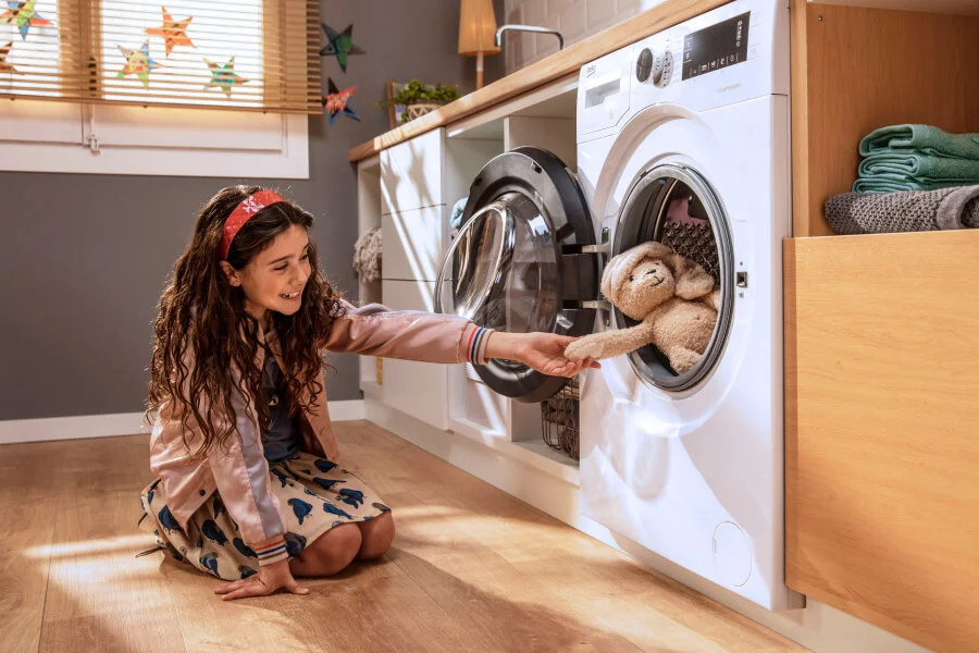Person unplugging a clothes dryer from the wall socket