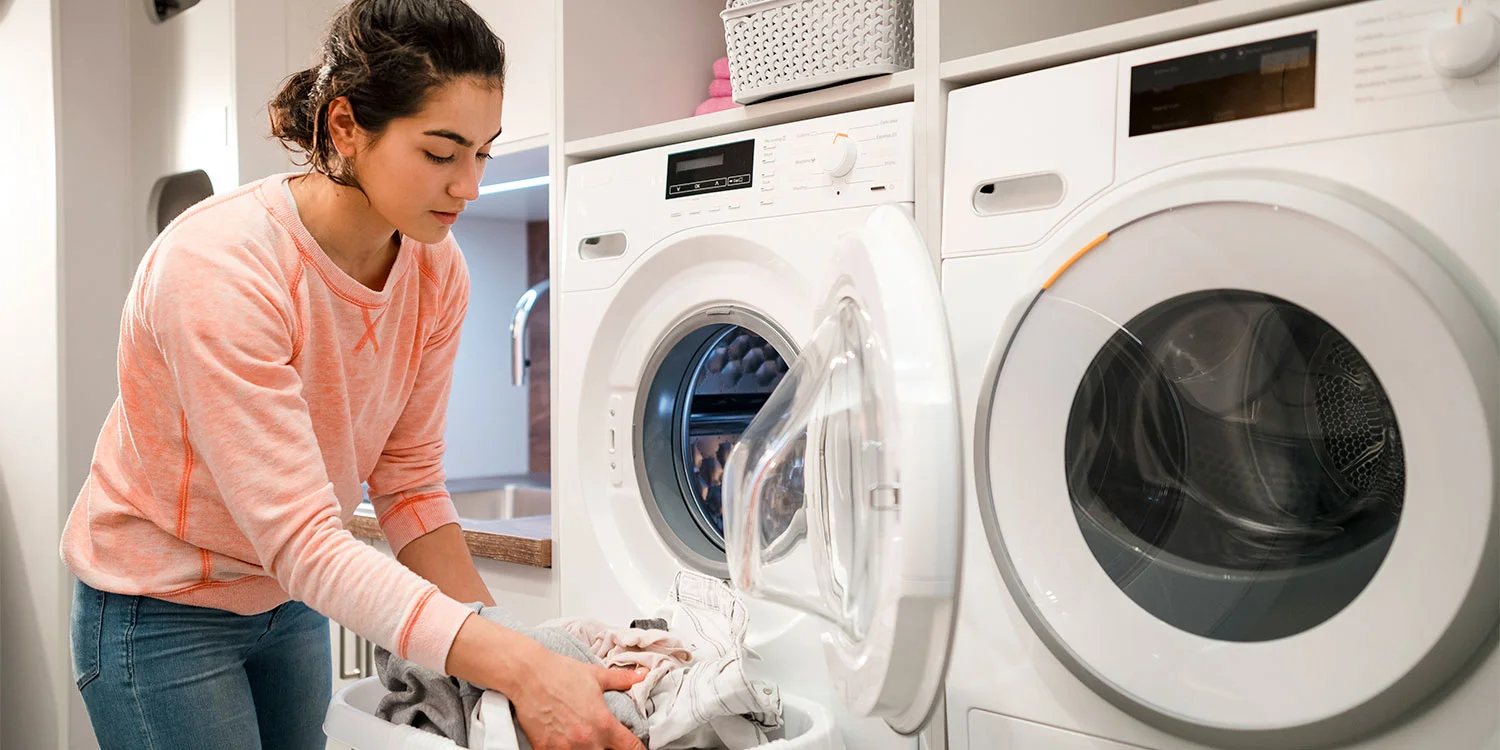 Person pausing a clothes dryer mid-cycle